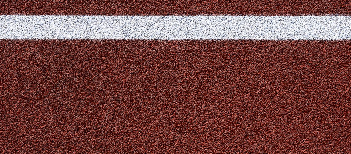 Red sports court or playground background with white line.